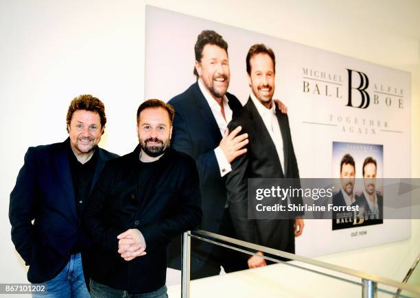 Michael Ball and Alfie Boe pose backstage after signing copies of their new album 'Together Again' at HMV Manchester on October 27, 2017 in...