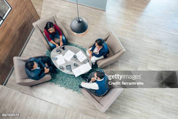 business meeting seen from above - round table discussion stock pictures, royalty-free photos & images