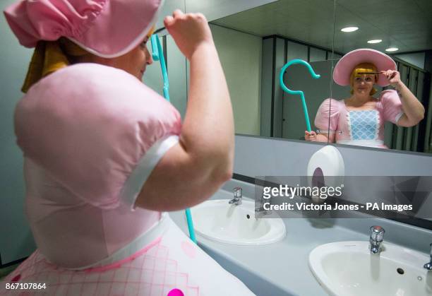 Cosplayer dressed as Little Bo Peep adjusts her costume at the London Comic Con at the ExCel London.