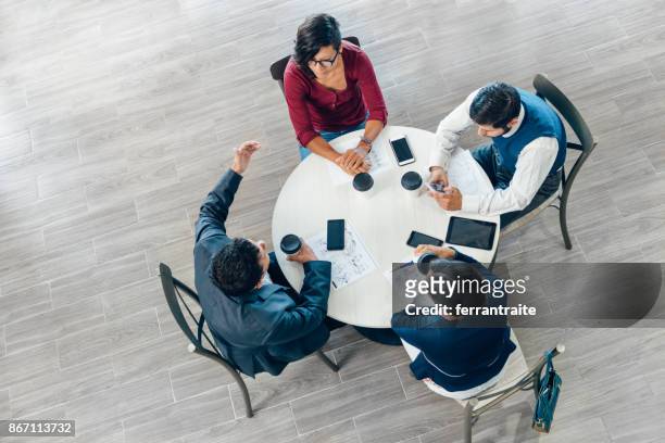 zakelijke bijeenkomst van bovenaf gezien - ronde tafel stockfoto's en -beelden