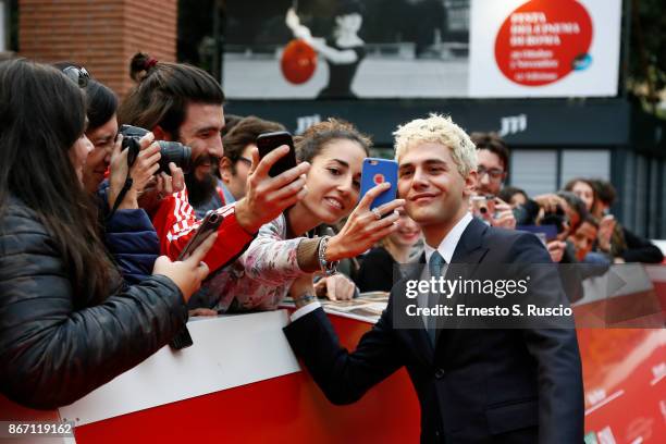 Xavier Dolan takes selfies with fans on the red carpet during the 12th Rome Film Fest at Auditorium Parco Della Musica on October 27, 2017 in Rome,...