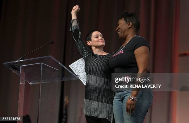 Actress Rose McGowan and Founder of #MeToo Campaign Tarana Burke, embrace on stage at the Women's March / Women's Convention in Detroit, Michigan, on...