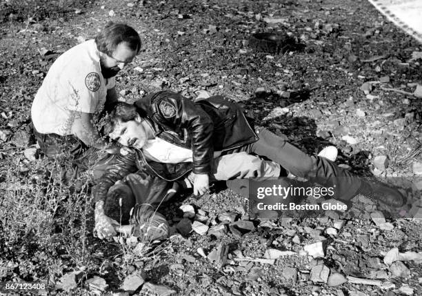 Paramedics Nick O'Neil and Kevin Shea pin down a youth suspected of snatching a purse from a teenage girl in Dorchester's Edward Everett Square in...