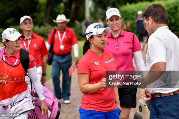 Kim Sei Young of South Korea is consulting with the referee about touching the ball in the bunker during day two of the Sime Darby LPGA Malaysia at...