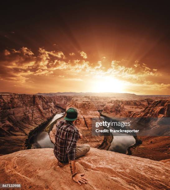 man resting at horseshoe bend in usa - grand canyon stock pictures, royalty-free photos & images