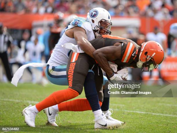 Wide receiver Ricardo Louis of the Cleveland Browns is tackled by linebacker Wesley Woodyard of the Tennessee Titans in the third quarter of a game...