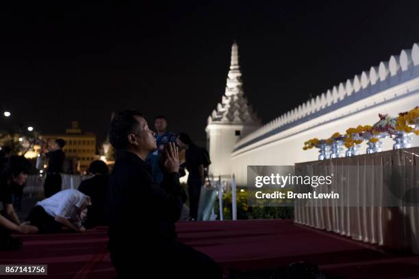 Mourners prostrate themselves outside Wat Phra Kaew, or the Temple of the Emerald Buddha on October 27, 2017 in Bangkok, Thailand. Tens of thousands...