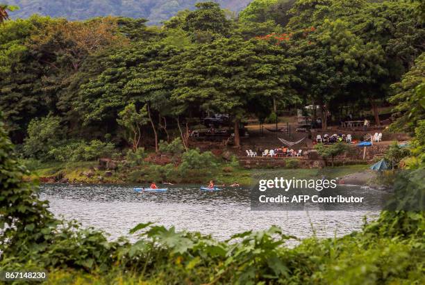 Tourists enjoy kayaking and swimming at the "Laguna de Apoyo" volcanic lagoon in Masaya, about 40 kilometres from Managua on October 14, 2017....