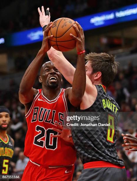 Quincy Pondexter of the Chicago Bulls tries to get off a shot against Luke Babbitt of the Atlanta Hawks at the United Center on October 26, 2017 in...
