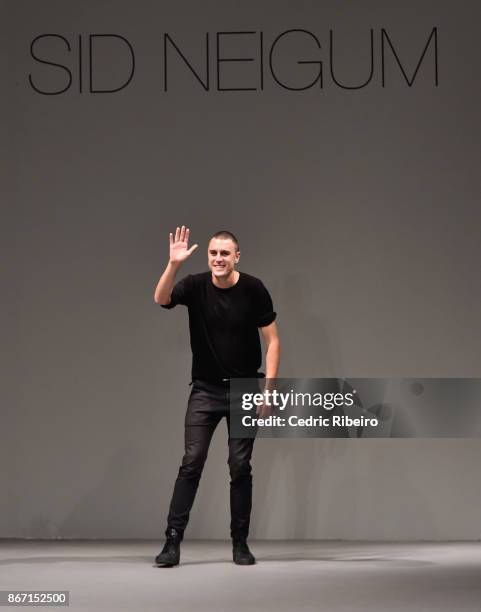 Fashion designer Sid Neigum walks the runway during the Sid Neigum International show at Fashion Forward October 2017 held at the Dubai Design...