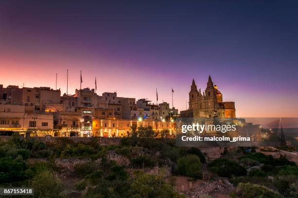 a purple sunset over the village of mellieha, malta - mellieha malta stock pictures, royalty-free photos & images