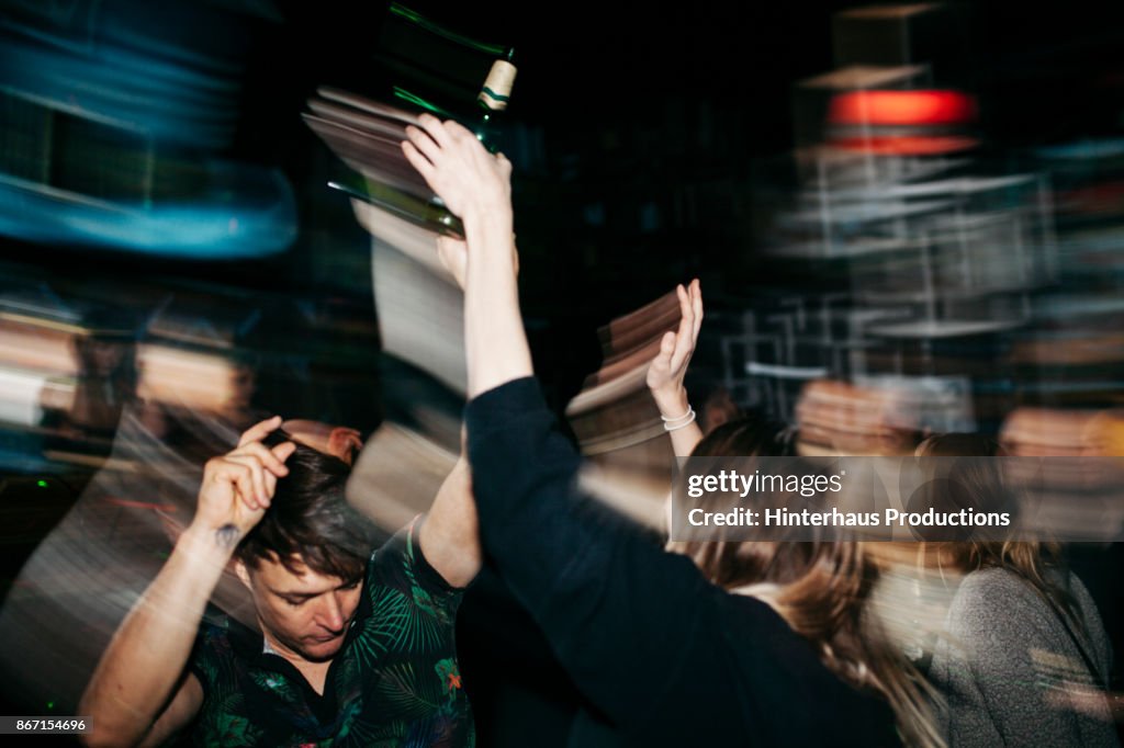 Energetic Scene Of People On Dancefloor At Nightclub
