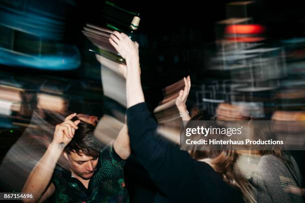 energetic scene of people on dancefloor at nightclub - party bildbanksfoton och bilder