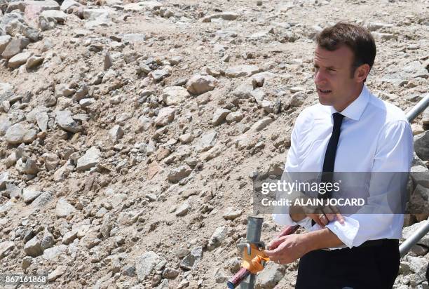 French president Emmanuel Macron, arrives to the Ariane 6 building site on October 27, 2017 at the Kourou space center, as part of a three-day visit...