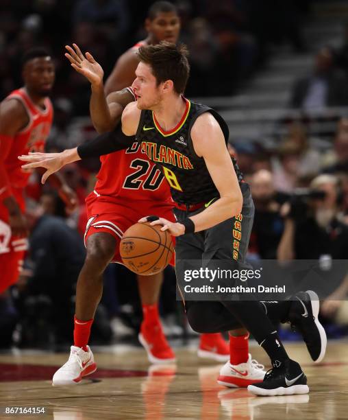 Luke Babbitt of the Atlanta Hawks moves around Quincy Pondexter of the Chicago Bulls at the United Center on October 26, 2017 in Chicago, Illinois....
