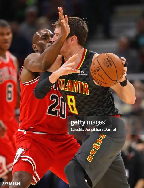 Luke Babbitt of the Atlanta Hawks moves around Quincy Pondexter of the Chicago Bulls at the United Center on October 26, 2017 in Chicago, Illinois....