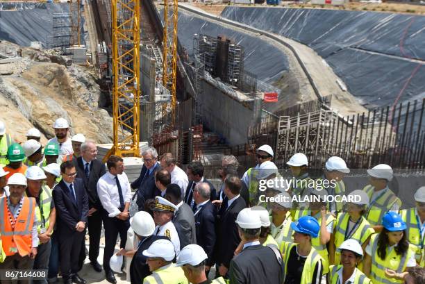 French president Emmanuel Macron , and European Commission President Jean-Claude Juncker meet with workers during a visit to the Ariane 6 building...