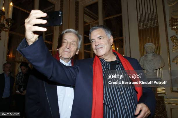 Honorary Israeli Filmmaker Amos Gitai poses with Director Constantin Costa-Gavras at the Ministere de la Culture where he was awarded the Chevalier...