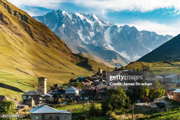 fortified stone towers (koshi) of ushguli village with mount shkhara (5193m, georgia's highest peak, great caucasus range) in background, upper svaneti (unesco world heritage site),  georgia - caucasus stock pictures, royalty-free photos & images