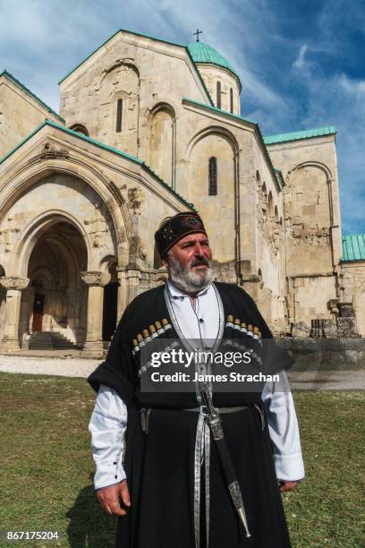 proud georgian man, in traditional cossack dress, outside bagrati cathedral, kutaisi, georgia (model release) - georgian man stock pictures, royalty-free photos & images