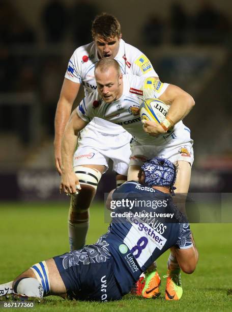 James Short of Exeter Chiefs is tackled by Josh Strauss of Sale Sharks during the Aviva Premiership match between Sale Sharks and Exeter Chiefs at AJ...