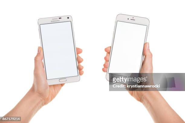 vergelijken van de iphone 6 plus en samsung galaxy note 4 wit weergeven - holding iphone stockfoto's en -beelden