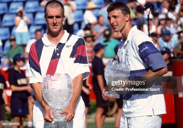 Men's singles champion Todd Martin of the USA and runner up Goran Ivanisevic of Croatia pose with their trophies after the Final of the Peters...