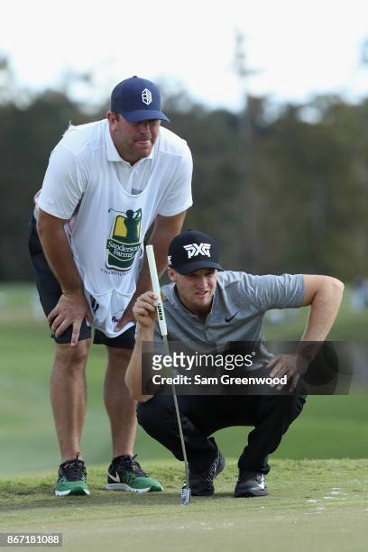 Wyndham Clark of the United States lines up a putt with his caddie on the eighth hole during the second round of the Sanderson Farms Championship at...