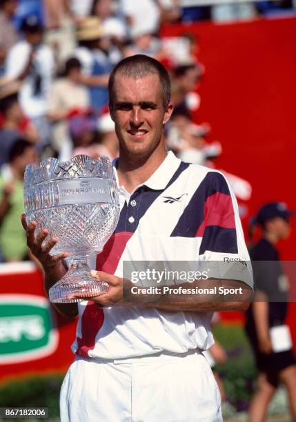 Todd Martin of the USA poses with the trophy after defeating Goran Ivanisevic of Croatia in the Final of the Peters International Tennis Tournament...