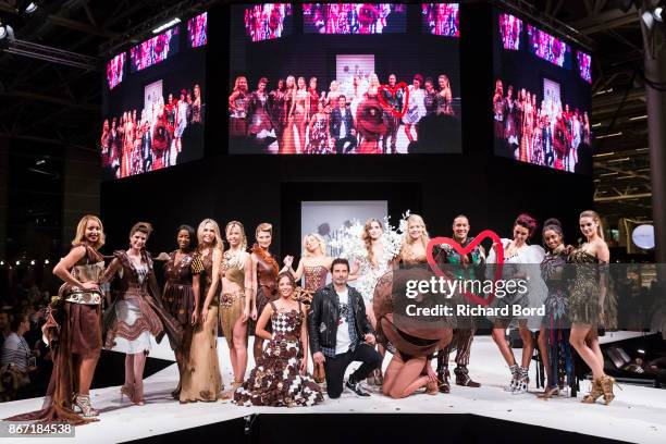 Models and Richard Orlinski pose on the runway during the Dress Chocolate show as part of Salon du Chocolat at Parc des Expositions Porte de...