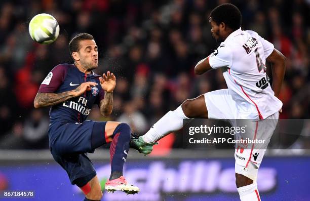 Paris Saint-Germain's Brazilian defender Dani Alves vies with Nice's Brazilian defender Santos Marlon during the French L1 football match between...