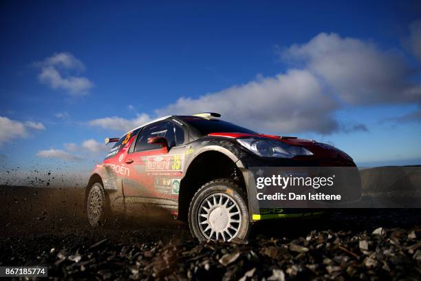 Simone Tempestini of Romania drives with co-driver Giovanni Bernacchini of Italy during day one of the FIA World Rally Championship Great Britain on...