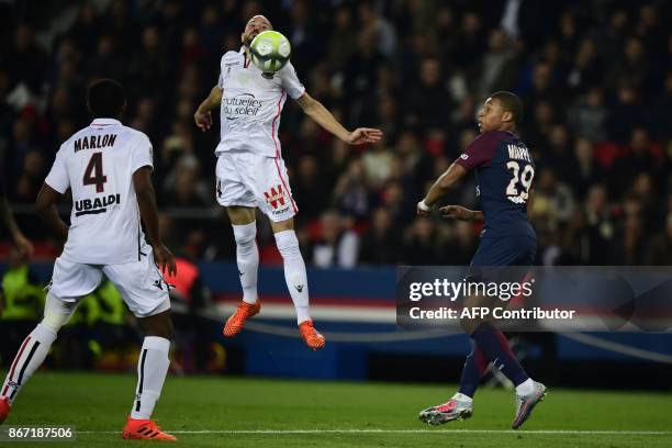 Paris Saint-Germain's French forward Kylian Mbappe vies with Nice's French defender Christophe Jallet and Nice's Brazilian defender Santos Marlon...