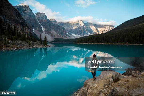 enjoying a scenic mountain view. - moraine lake stock-fotos und bilder