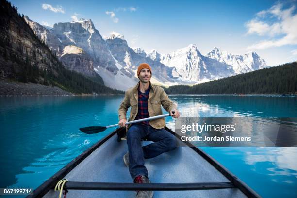 canoeing on a turquoise lake - canada mountains ストックフォトと画像