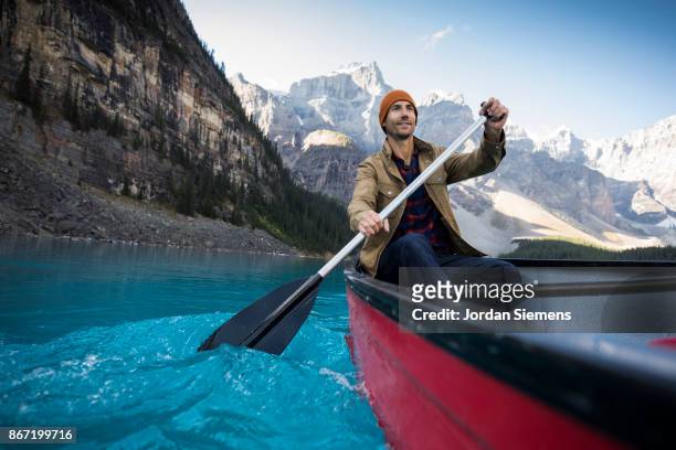 canoeing on a turquoise lake - banff stock-fotos und bilder
