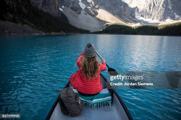 canoeing on a turquoise lake - boat rowing stock pictures, royalty-free photos & images