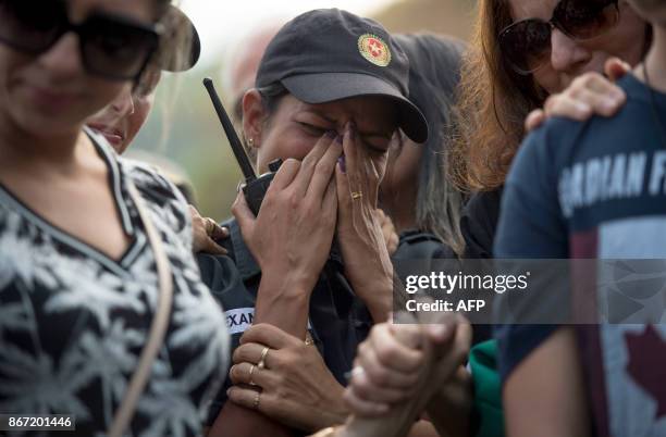 Military policewoman cries at the funeral of police colonel Luis Gustavo Teixeira in Sulacap, in western Rio de Janeiro, Brazil, on October 27 a day...