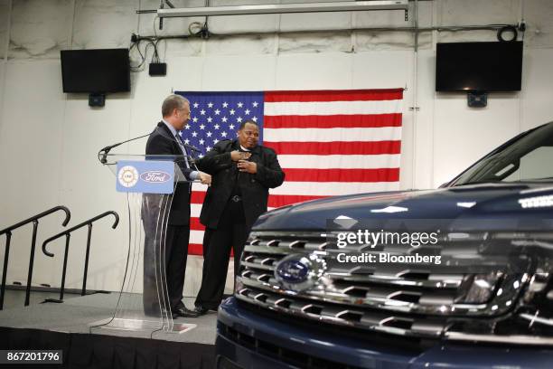 Houston Pastor Develron Walker, who lost his vehicle in the Houston floods, right, reacts after being given a new Expedition sports utility vehicle...