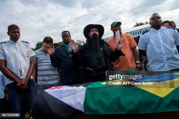 Relatives and police officers pray during the funeral of police colonel Luis Gustavo Teixeira in Sulacap, in western Rio de Janeiro, Brazil, on...