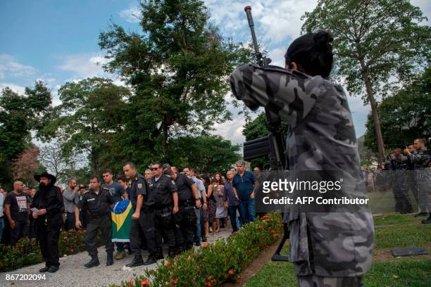 Military Police soldiers pay tribute to police colonel Luis Gustavo Teixeira during his funeral in Sulacap, in western Rio de Janeiro, Brazil, on...