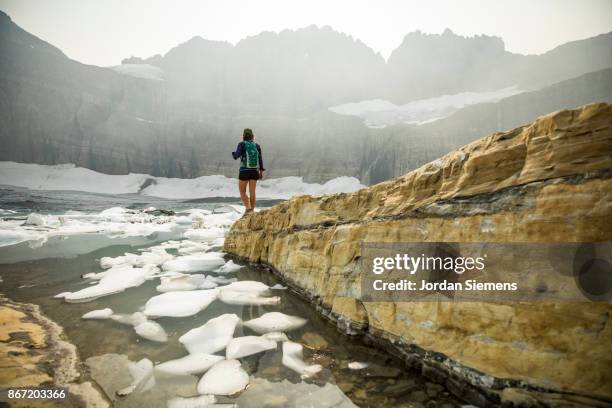 hiking past an iceberg lake - ice floe stock pictures, royalty-free photos & images