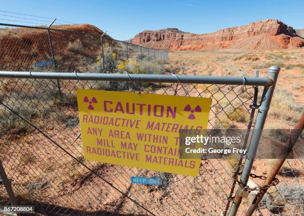 Radioactive warning sign hangs on fencing around the Anfield's Shootaring Canyon Uranium Mill on October 27, 2017 outside Ticaboo, Utah. Anfield with...