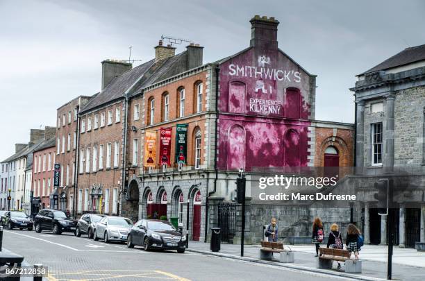 smithwick's wall painting advertisement in kilkenny ireland during day of autumn - kilkenny ireland stock pictures, royalty-free photos & images