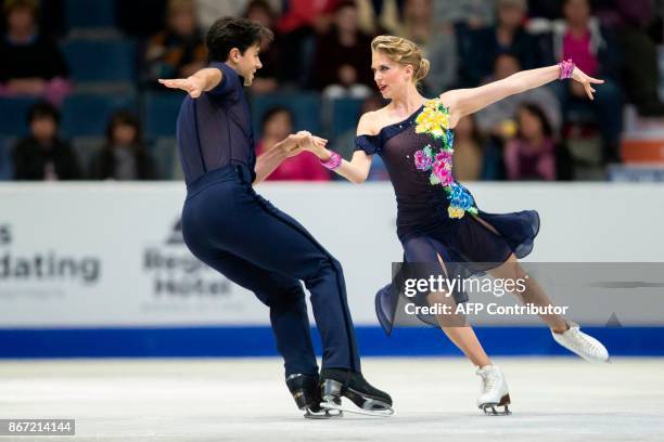 Kaitlyn Weaver and Andrew Poje of Canada perform their short program at the 2017 Skate Canada International ISU Grand Prix event in Regina,...