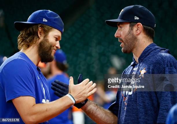 Clayton Kershaw of the Los Angeles Dodgers shakes hands with Justin Verlander of the Houston Astros before game three of the 2017 World Series at...
