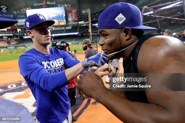 Cody Bellinger and Yasiel Puig of the Los Angeles Dodgers play with a rubber snake before game three of the 2017 World Series against the Houston...