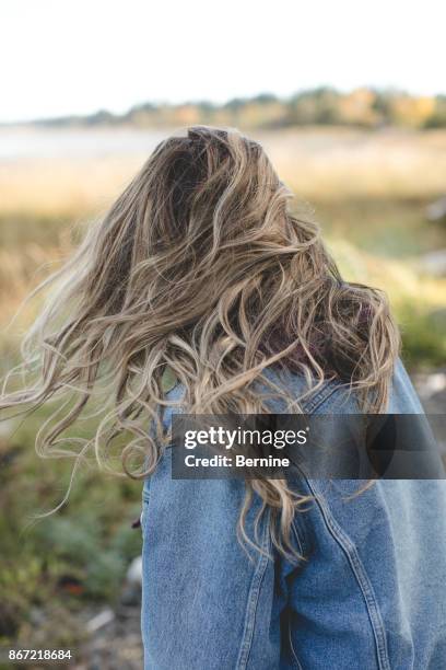 back young woman with windswept hair - maroon hair stock pictures, royalty-free photos & images