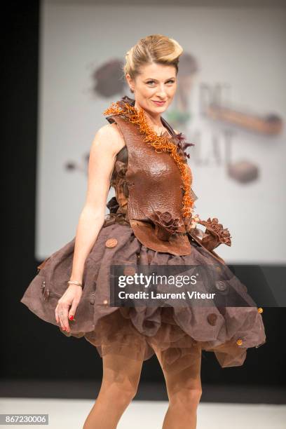 Presenter Sandrine Arcizet walks the Runway during "Le Defile des Robes en Chocolats" during the "Salon du Chocolat Paris 2017" at Parc des...