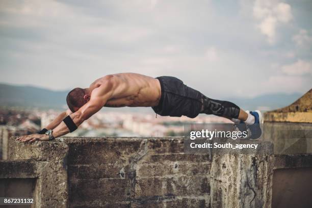 man doing hard push ups - push limit stock pictures, royalty-free photos & images
